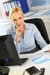 Photo: Businesswoman reading document at work Businesswoman reading document at work