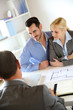 Couple meeting real-estate agent to buy property