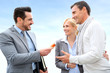 Salesman giving home keys to property owners