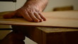 Luthier with hacksaw cuts wood for a flamenco guitar