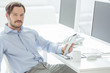 Photo: Handsome businessman sitting in front of monitors Handsome businessman sitting in front of monitors