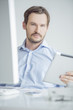 Photo: Attractive male sitting at his desk Attractive male sitting at his desk
