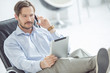 Photo: Relaxed businessman talking mobile phone Relaxed businessman talking mobile phone