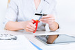 Photo: Businesswoman cutting credit card Businesswoman cutting credit card