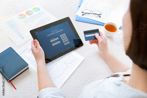 Photo: Businesswoman using a credit card for online internet banking Businesswoman using a credit card for online internet banking