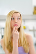 Portrait of thoughtful teenager girl in kitchen