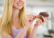 Closeup on chocolate muffin in hand of teenager girl