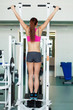 young fitness model works out on training apparatus