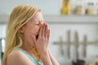 Portrait of yawing young woman in the morning in kitchen