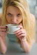 Portrait of young woman drinking coffee in the morning