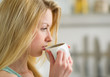 Portrait of young woman drinking coffee in the morning