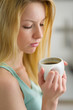 Portrait of young woman drinking coffee in the morning
