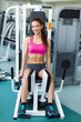 young fitness model works out on training apparatus