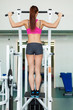 young fitness model works out on training apparatus