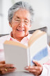 Beautiful old woman reading a book