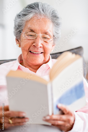 Photo: Beautiful old woman reading a book Beautiful old woman reading a book