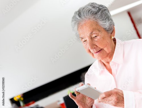 Photo: Senior woman using a smart phone Senior woman using a smart phone