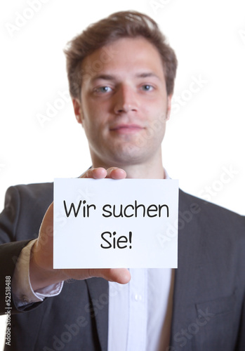 Photo: Junger Mann im Anzug mit Karte WIR SUCHEN SIE! Junger Mann im Anzug mit Karte WIR SUCHEN SIE!