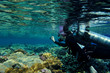 Female diver taking film underwater