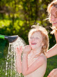 Foto: Child taking a shower outdoors Child taking a shower outdoors