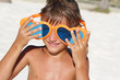 young happy child playing on tropical beach