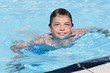Activities on the pool. Cute boy swimming and playing in water i