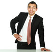 Photo: A young man standing near desk, isolated on white background A young man standing near desk, isolated on white background