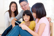 Asian family using tablet computer