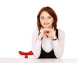 business woman with gift box with red bow sitting at the desk