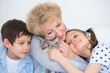 Portrait of smiling grandmother and grandchildren hugging