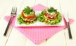 Tasty roasted marrow and tomato slices with salad leaves,