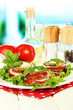 Tasty roasted marrow and tomato slices with salad leaves,