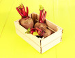 Young beets on wooden box on wooden table close-up