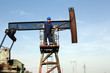 oil worker on pump jack