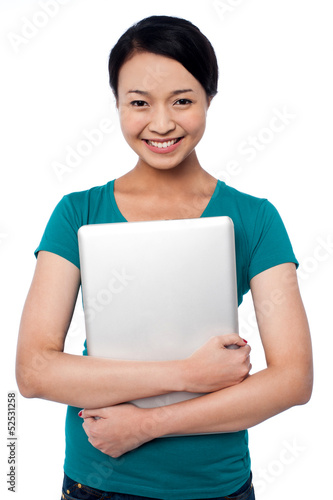 Photo: Smiling asian female posing with laptop Smiling asian female posing with laptop