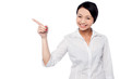 Photo: Happy young girl pointing at copy space area Happy young girl pointing at copy space area