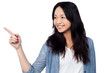 Young chinese girl pointing and looking outside