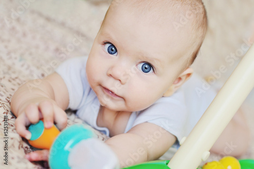 Photo: blue eyed baby with toys blue eyed baby with toys