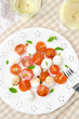 salad with mini mozzarella, cherry tomatoes, basil, top view