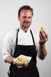 young chef holding bowl with potatos