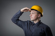 engineer in helmet looks into the distance