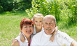 Outdoors portrait of grandparents with granddaughter