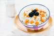 Bowl of cottage cheese with berries on light background
