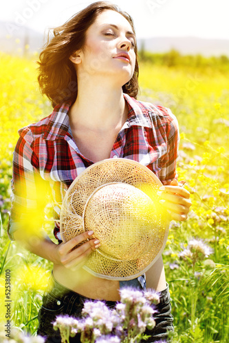 Photo: Portrait of young woman in the flowers field Portrait of young woman in the flowers field