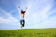 Young beautiful woman jumping for joy