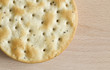 One round cracker on wooden board