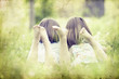 Photo: Old photo of happy children lying on green grass outdoors Old photo of happy children lying on green grass outdoors