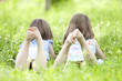 Photo: Happy children lying on green grass outdoors Happy children lying on green grass outdoors