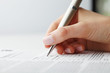 Businesswoman writing on a form