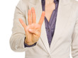 Closeup on business woman showing four with fingers